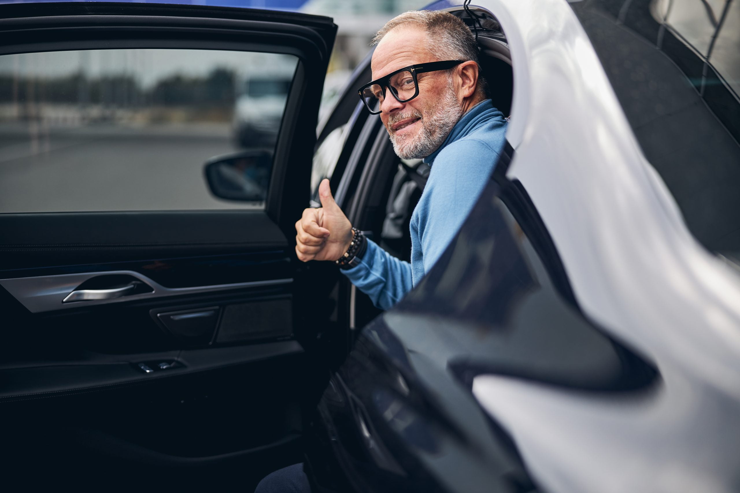 Satisfied client stepping out of a chauffeured car